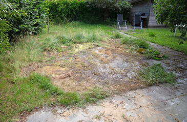 Big yellow dead space in a green field of grass