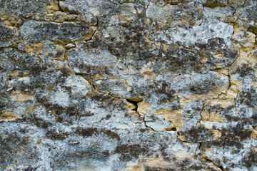 the surface of an old cracked wall, weathered layers crumble, painted in gray and blue colors, for background or texture, an old house in the village
