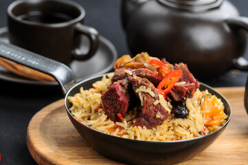 stewed rice with meat in a pan
