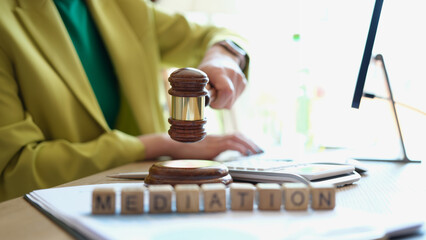 Female hand striking gavel in court room