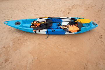 Cayak with equipment on the beach,travel leisure time,summer - blue kayak on the beach.

