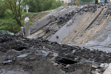 Destroyed bridge across the river The civilian facility was blown up. War in Ukraine. Destroyed infrastructure. Broken communications. humanitarian catastrophe