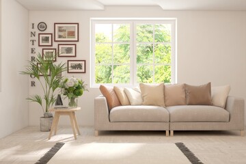 Fototapeta premium White living room with sofa and summer landscape in window. Scandinavian interior design. 3D illustration