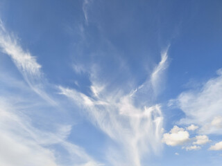 Naklejka na ściany i meble White clouds disperse on blue sky background ,in a clear day