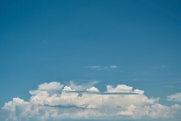 Blue summer sky background with cumulus clouds, idea for screensaver or wallpaper for screen or advertisement, free space for text