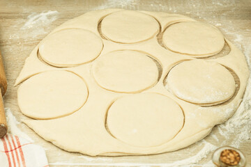 Dough rolled out on the table in the form of cakes