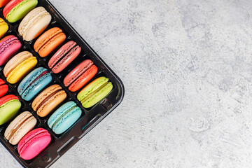 Colorful french dessert macarons with fresh fruits and nuts.