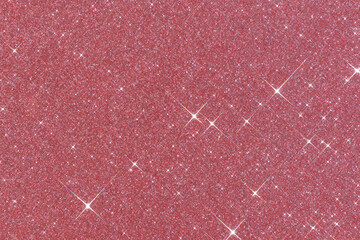 Sparkling texture. Abstract pink background with sparkles in the shape of stars. Festive backdrop...