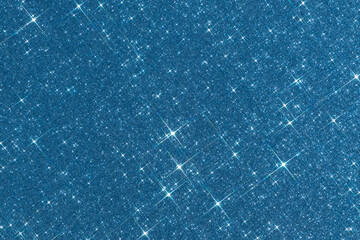 Sparkling texture. Abstract blue background with sparkles in the shape of stars. Festive backdrop...