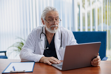 Fototapeta premium Therapist conducts video consultations, communicates with the patient through call by laptop