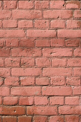 Background with a pattern of brickwork. Antique brickwork of fired clay bricks painted over with reddish paint and covered with dust.