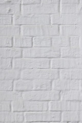 Background with a pattern of brickwork. Ancient brickwork of baked clay bricks densely painted over with white lime.