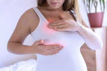 Breast pain self exam. Young pregnancy woman examining breast for signs lumps. Breast self exam....