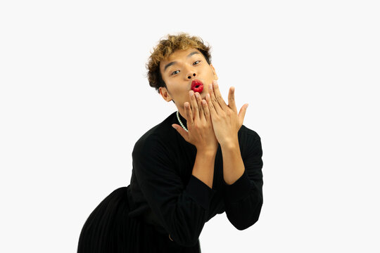 Happy Pretty Gay Man With Oops Posing In A Black Dress. Transgender  Isolated White Wall. LGBTQ+ Concept