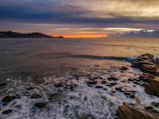 Sunrise over the sea with high cloud filled sky