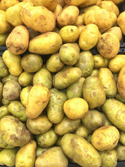 Fresh potatoes on the supermarket shelf.