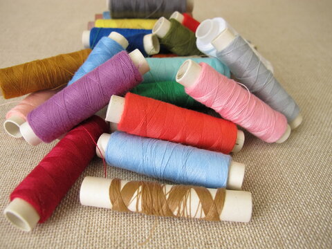Sewing thread in different colors on farbric