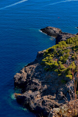 Beautiful view on the sea next to a huge mountain on the pretty island mallorca. Like a drone pic