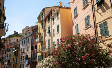 Fototapeta na wymiar Travel to Cinque Terre (English Five Lands). A beautiful view of Riomaggiore city at the coast of Mediterranean Sea. Travel to Italy, 2022.