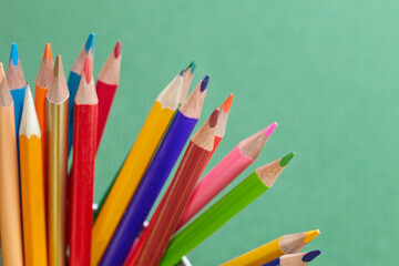 Fototapeta premium color pencils on the green texture