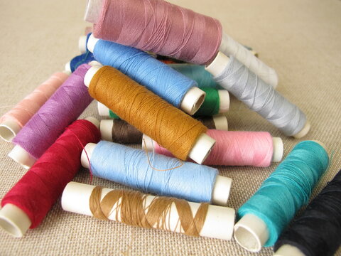 Sewing thread in different colors on farbric
