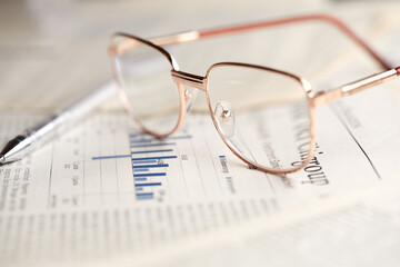 eyeglasses on the newspaper pages