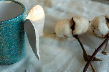 An empty cup for coffee or tea on the white background with shadows