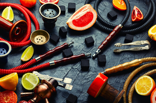 Smoking hookah with citrus fruits.