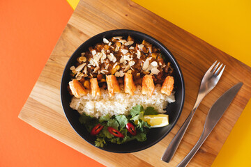 Asian cuisine. Shrimp with curry rice. Appetizing dish on an orange background