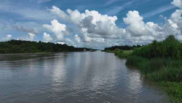 Busy industrial canal with 2 barge and push boats in Louisiana.