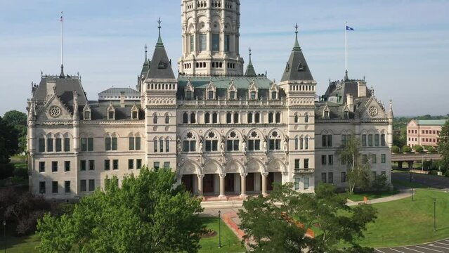 Connecticut state capitol building in Hartford, Connecticut with drone video moving up from trees.