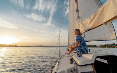 Luxury travel on the yacht. Young happy woman on boat deck sailing the river.