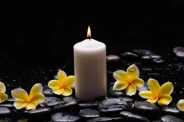 Foto op Canvas Still life of with yellow Plumeria, frangipani with candle  zen black stones on wet background © Mee Ting