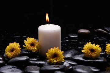 Foto op Aluminium Still life of with  Five yellow flower , and  candle and zen black stones on wet background  © Mee Ting