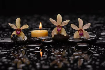Keuken spatwand met foto Still life of with  Yellow orchid  and candle with zen black stones on wet background,  © Mee Ting