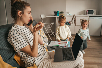 Female freelancer and her two daughters at home