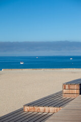 Obraz premium Blue sea minimalist composition. A light wooden bench, the blue sea, the blue sky, lines and harmonious geometric shapes.