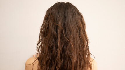 Naklejka premium Curly brunette girl with natural curly hair. Wavy curls, cgm
