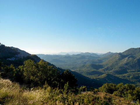 Scenic mountain landscape, view of the mountain range with the forest, green trees, and blue sky