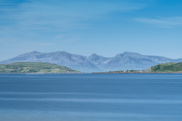 A hazy Isle of Arran taken on a bright sunny day in Scotland's Portencross Bay