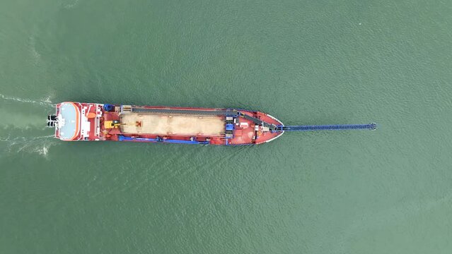 Bird's Eye View of a Self Unloading Barge Carrying Cargo At Sea