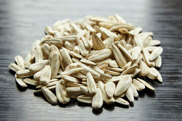 Sunflower seeds heap over wooden background