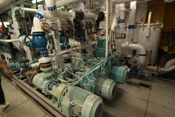 Cruise ship engine room interior with water tight doors electrical and diesel engines, water pipes,...