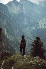 Obraz premium A vertical shot of a woman hiking in the Alpstein, Appenzell Alps in Switzerland