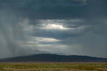 Naklejka premium dramatic storm clouds over mountains
