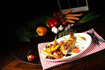 Fototapeta na wymiar Rustic fried chicken legs with assorted vegetables and rice