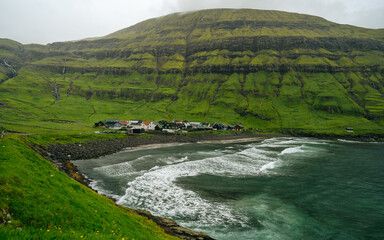 Beautiful view of the Tjornuvik village in the middle of the Mountains in Faroe Island