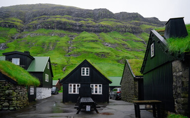 Beautiful view of the Tjornuvik village in the middle of the Mountains in Faroe Island