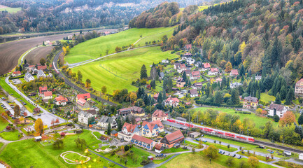 Picturesque autumn landscape in Saxon Switzerland National Park. Rathen village from viewpoint of Bastei.