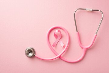 Breast cancer awareness concept. Top view photo of pink silk ribbon and stethoscope on isolated...